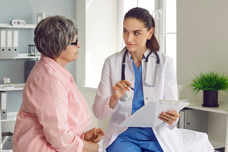 Woman talking with doctor about hearing loss and menopause